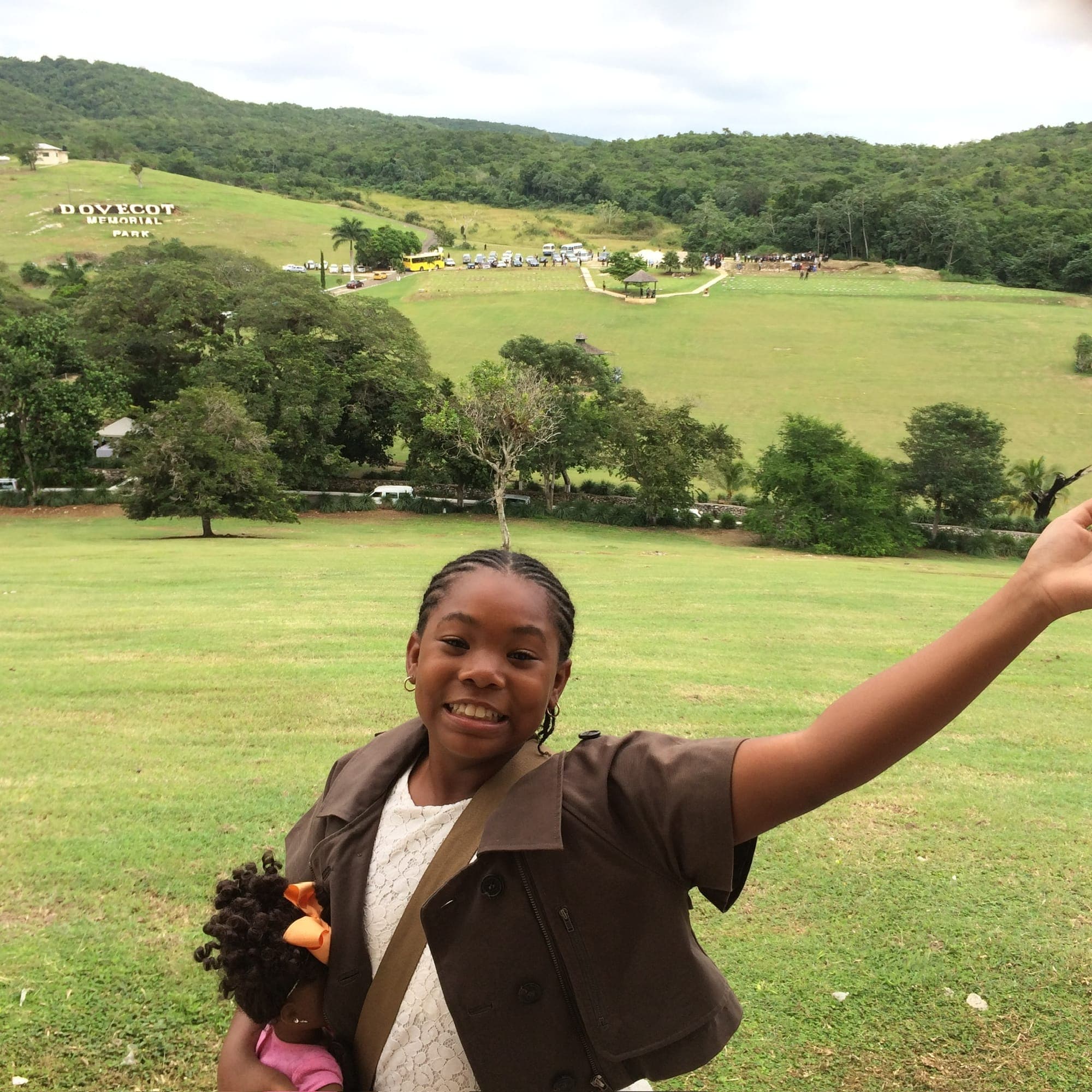 A smiling girl above the sweeping lawns